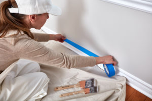 Woman applying painters tape