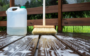 Deck brush with deck cleaner. Cleaning the deck